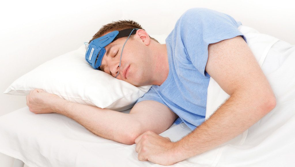 man sleeping with a CPAP machine